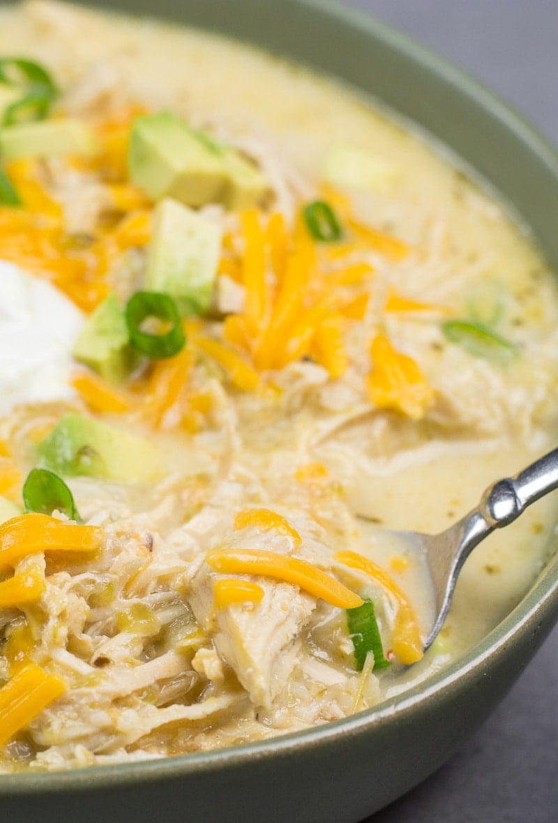 This Keto White Chicken Chili is loaded with shredded chicken, chilis, peppers and cauliflower rice! At about 7.5 net carbs per heaping serving this is the ultimate creamy keto comfort food!