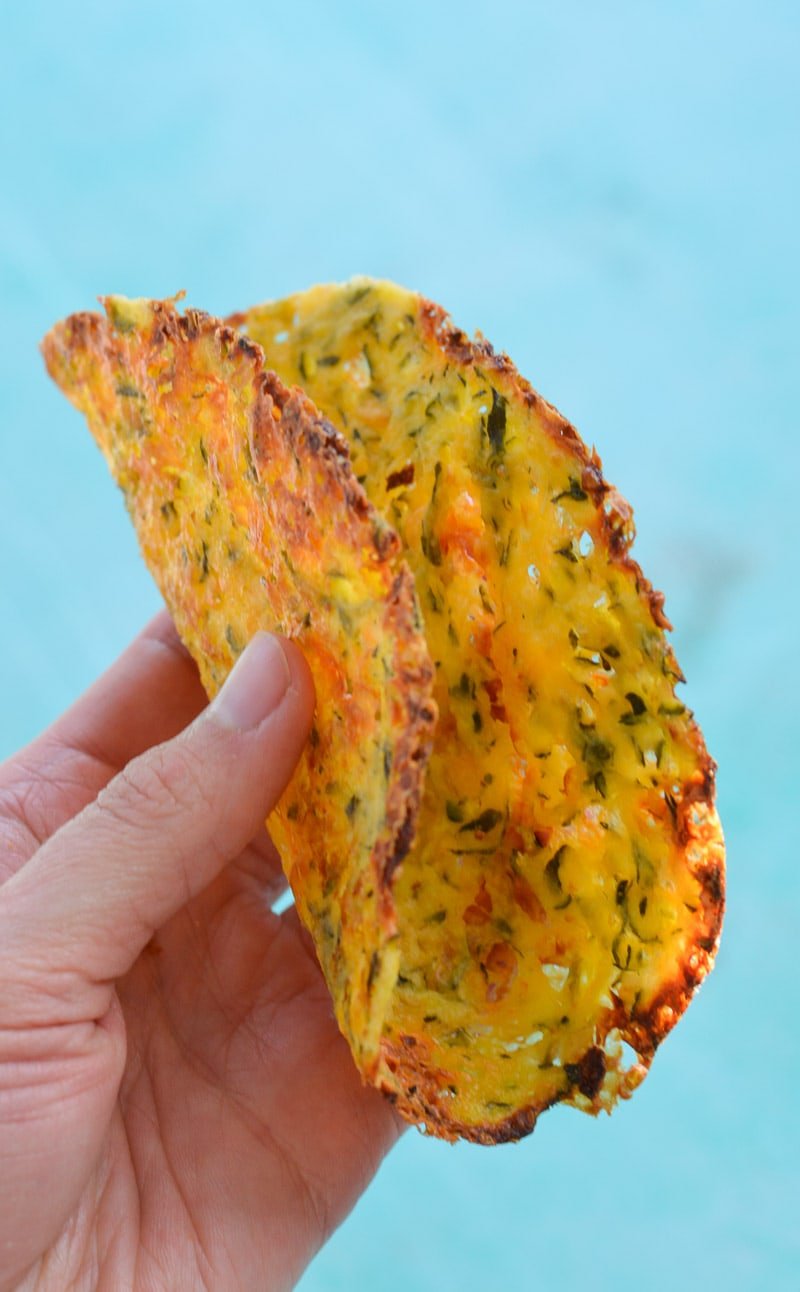 a keto friendly tortilla being held aloft 