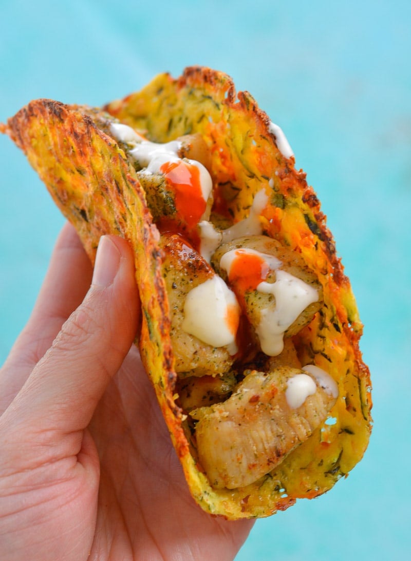 a keto chicken taco being held aloft 