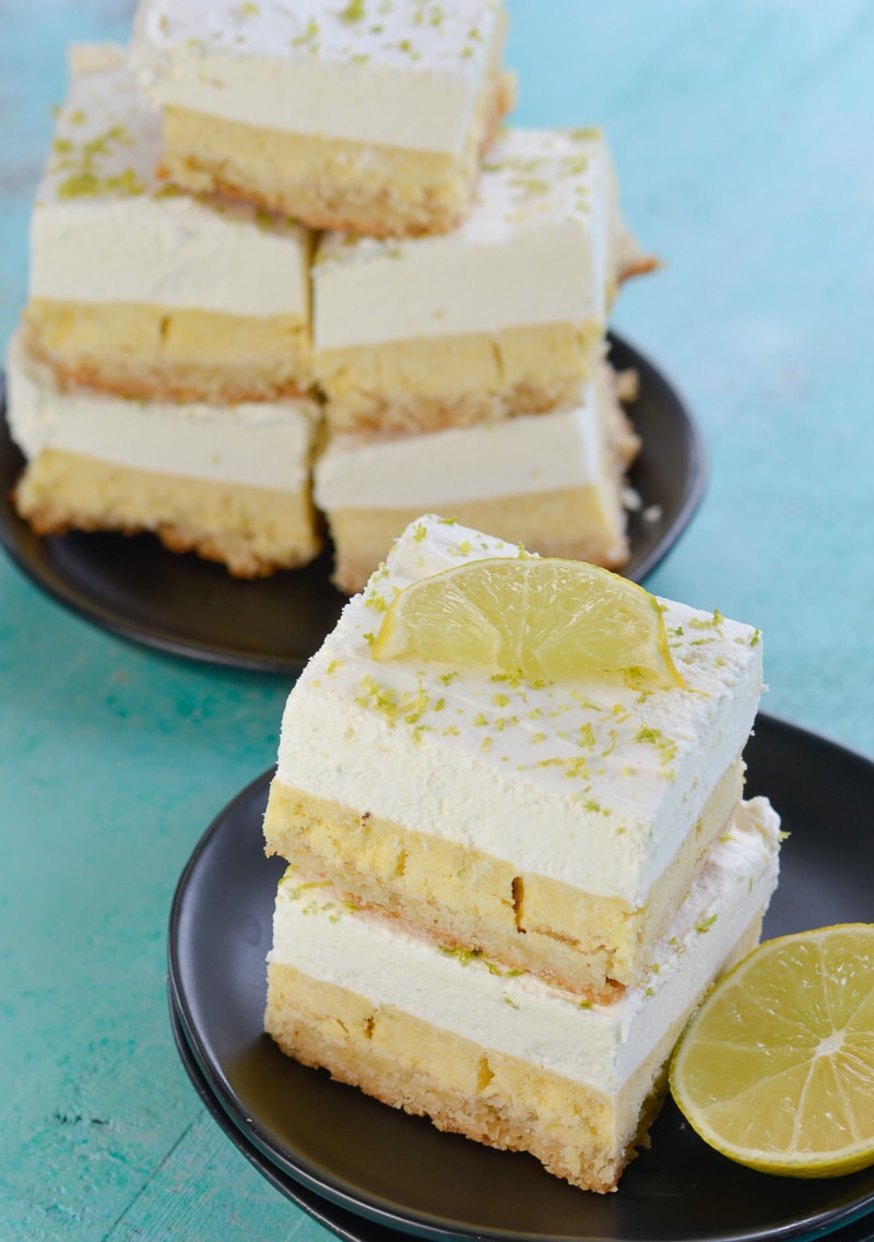 Stacks of keto key lime pie bars on two gray plates. 