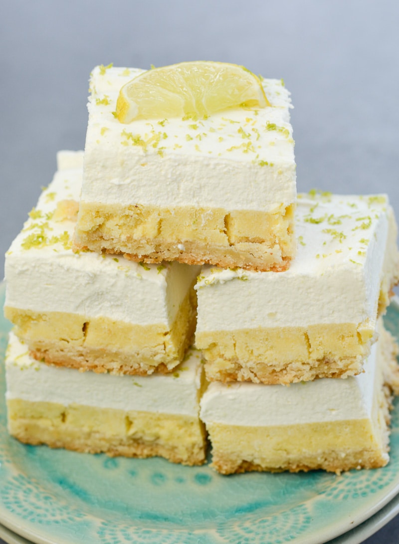 A stack of five keto key lime bars on a blue plate. 