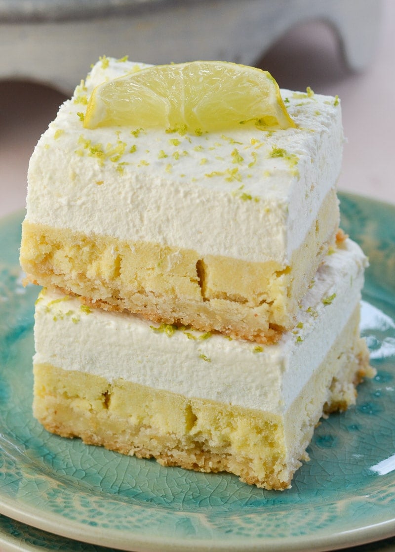 A stack of two key lime pie bars on a plate. 