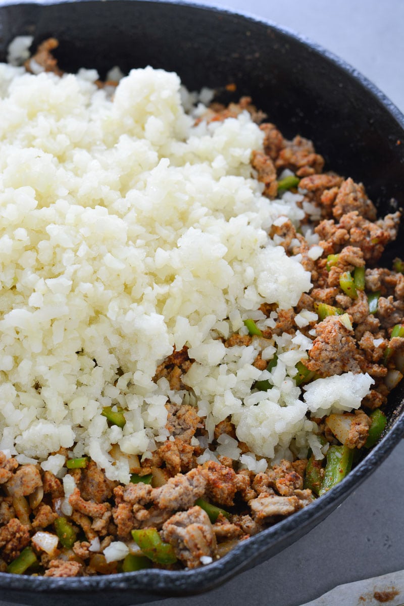 This Easy Keto Taco Skillet is packed with taco meat, cauliflower rice, vegetables and cheese. This is perfect for keto lunch meal prep or a quick and easy dinner around 6 net carbs per serving!