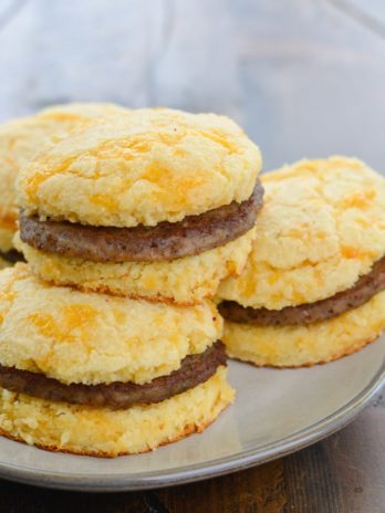 Try this Keto Sausage and Biscuit Recipe for an easy low carb breakfast! These Keto Almond Flour Biscuits are stuffed with cooked sausage patties for a high protein low carb breakfast!