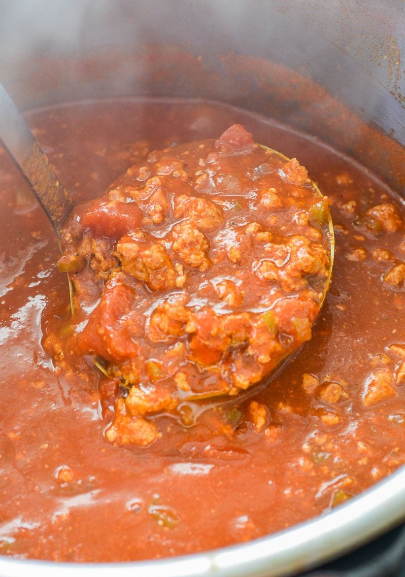 Close up of a ladle full of no bean chili in an Instant Pot. 