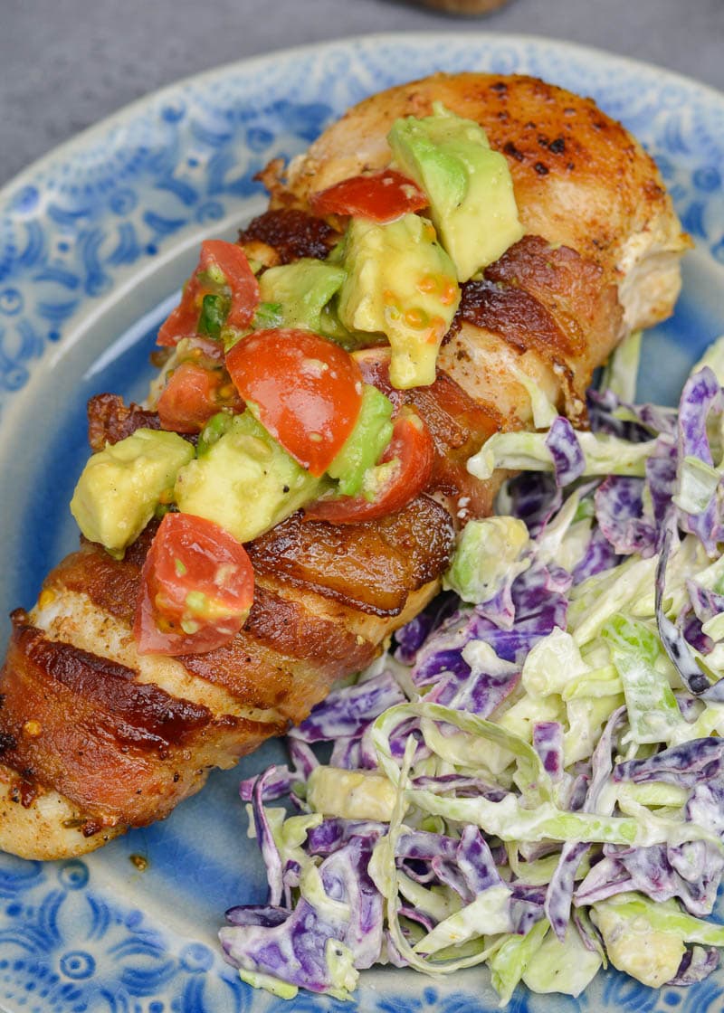 Enjoy Bacon Wrapped Chicken with Avocado Salsa for an easy weeknight meal! This low carb dish contains just 3 net carbs per serving and is ready in under 30 minutes!