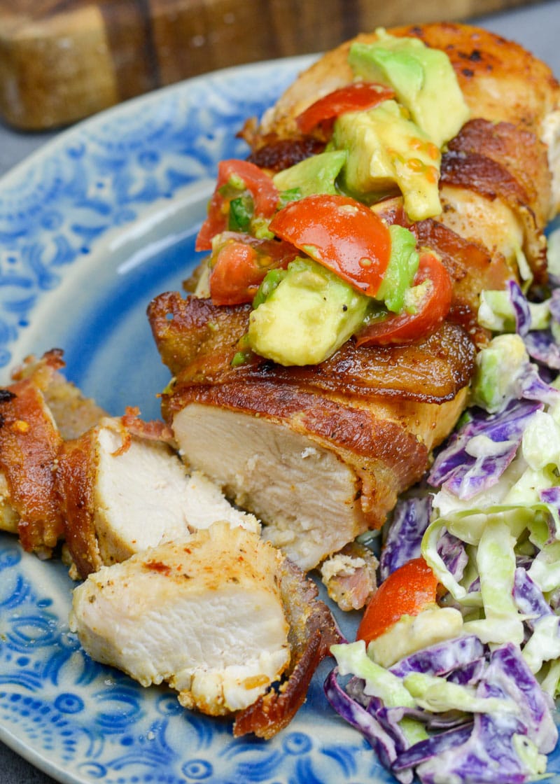 Enjoy Bacon Wrapped Chicken with Avocado Salsa for an easy weeknight meal! This low carb dish contains just 3 net carbs per serving and is ready in under 30 minutes!