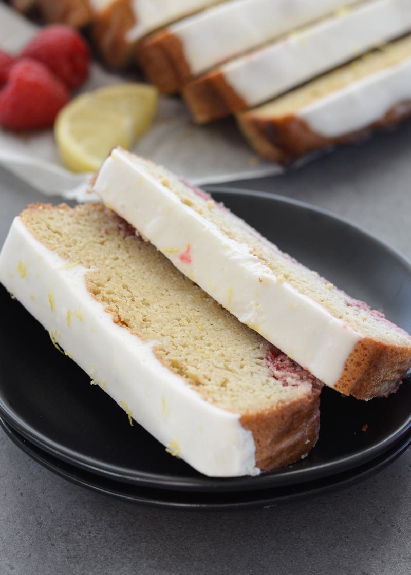 Enjoy a slice of Keto Lemon Raspberry Bread topped with Lemon Cream Cheese Glaze for under 3 net carbs per slice!