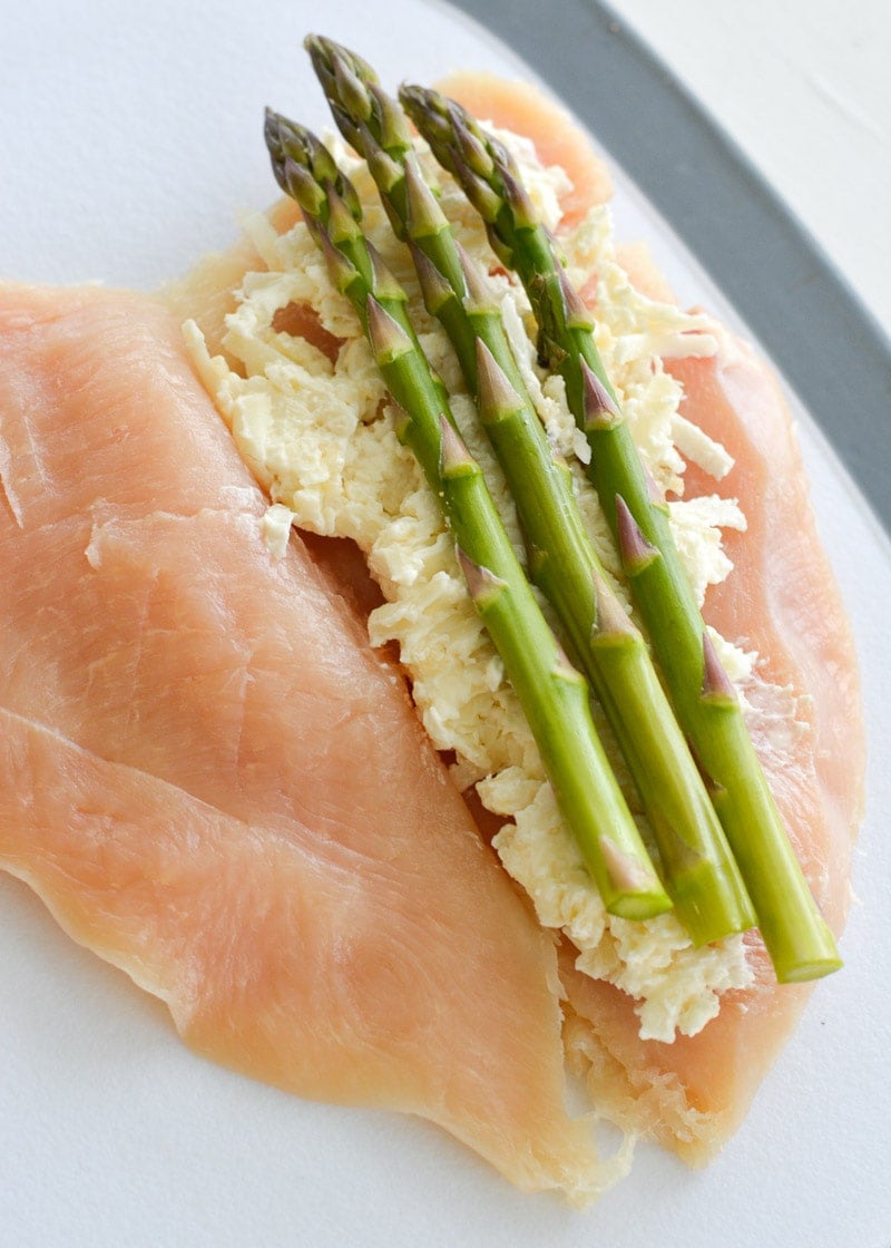 This Asparagus Stuffed Chicken is loaded with two kinds of cheese, tender asparagus and is rubbed with an Italian herb mix. This one pan, low carb recipe has about 2 net carbs per serving and is ready in 30 minutes. 