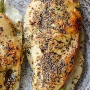 This Asparagus Stuffed Chicken is loaded with two kinds of cheese, tender asparagus and is rubbed with an Italian herb mix. This one pan, low carb recipe has about 2 net carbs per serving and is ready in 30 minutes. 