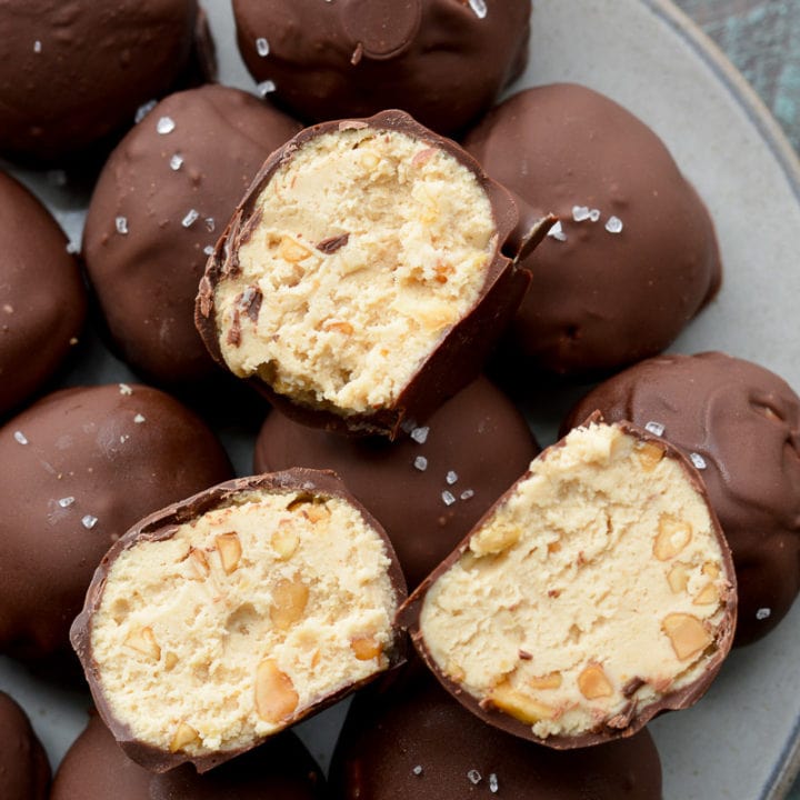 These Keto Peanut Butter Cheesecake Truffles require just 6 ingredients and no baking! These low carb delights are about one net carb each and perfect for satisfying your sweet tooth! 