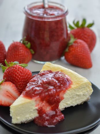  This Keto Cheesecake with Strawberry Sauce is the perfect low-carb treat to enjoy fresh berries this summer! 