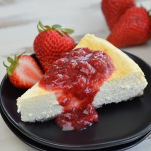  This Keto Cheesecake with Strawberry Sauce is the perfect low-carb treat to enjoy fresh berries this summer! 