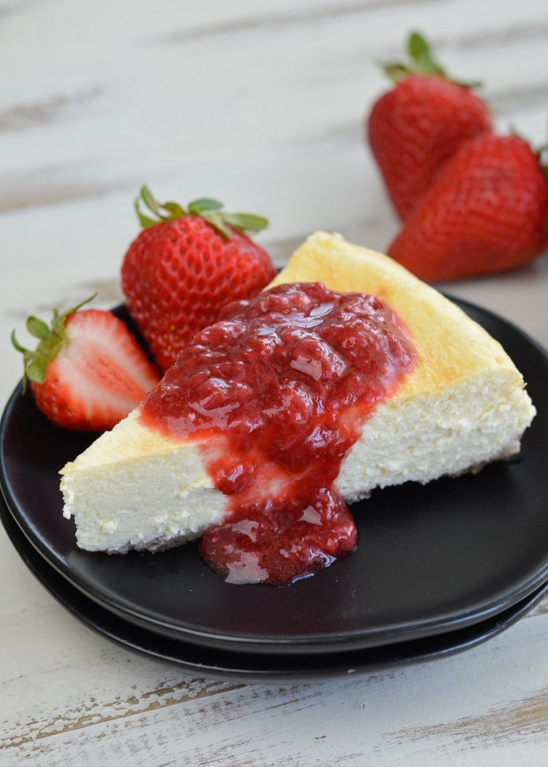  This Keto Cheesecake with Strawberry Sauce is the perfect low-carb treat to enjoy fresh berries this summer! 