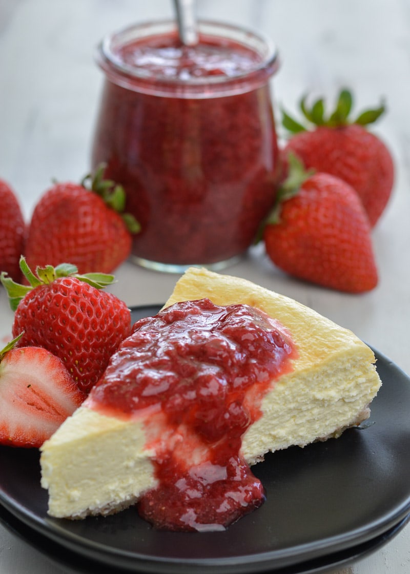  This Keto Cheesecake with Strawberry Sauce is the perfect low-carb treat to enjoy fresh berries this summer! 