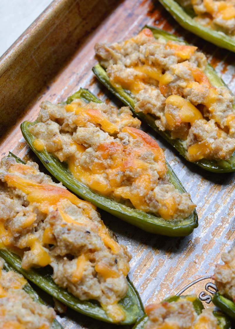 Keto Sausage Stuffed Jalapeno Poppers are the ultimate low carb appetizer! Each generous serving size has less than 3 net carbs!