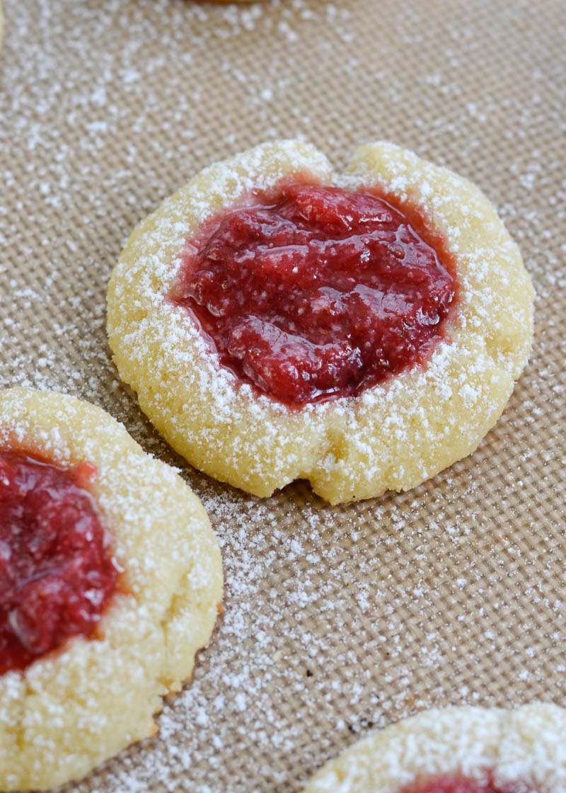 Keto Strawberry Thumbprint Cookies are the perfect sweet treat for about 2 net carbs each! Low carb sugar cookies are packed with fresh strawberry sauce and baked until soft and chewy! 