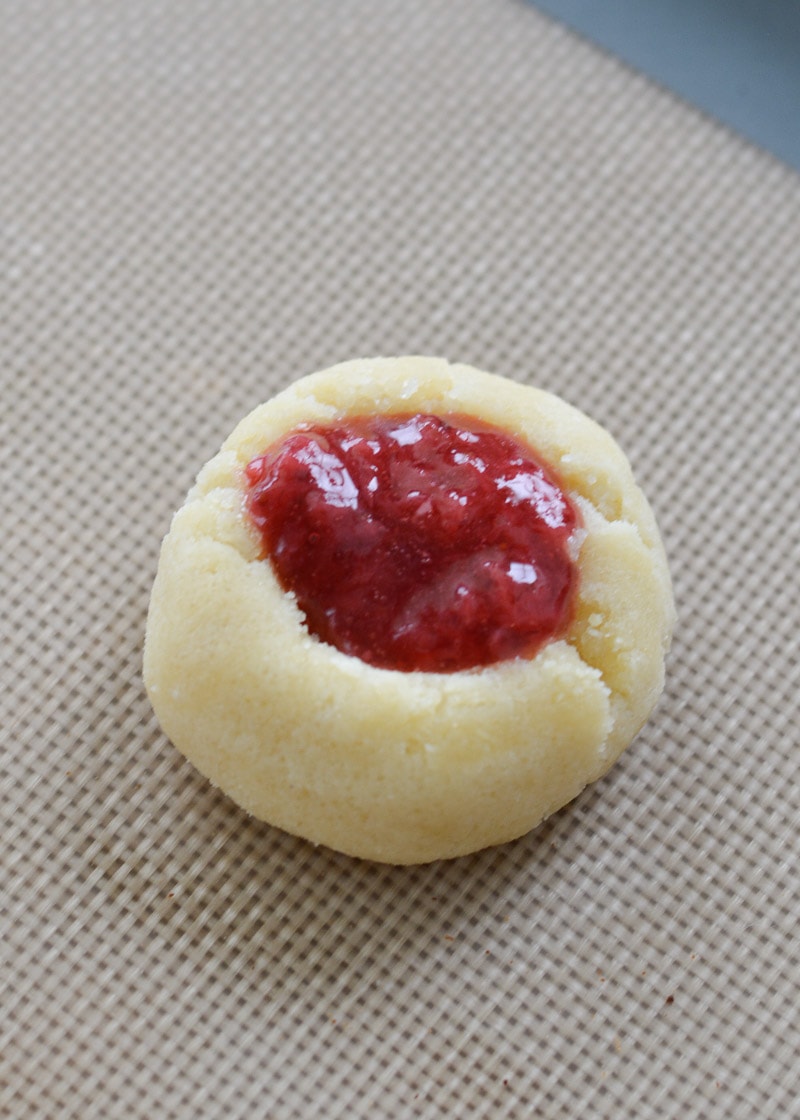 Keto Strawberry Thumbprint Cookies are the perfect sweet treat for about 2 net carbs each! Low carb sugar cookies are packed with fresh strawberry sauce and baked until soft and chewy! 