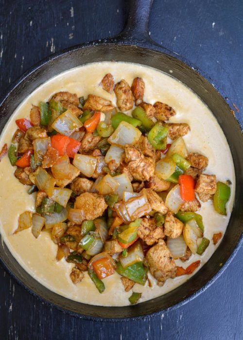This One Pan Cheesy Fajita Chicken is a delicious combo of flavorful chicken, fresh veggies and an amazing cheese sauce your family will devour! Great for low carb meal-prepping and clean up is a breeze!