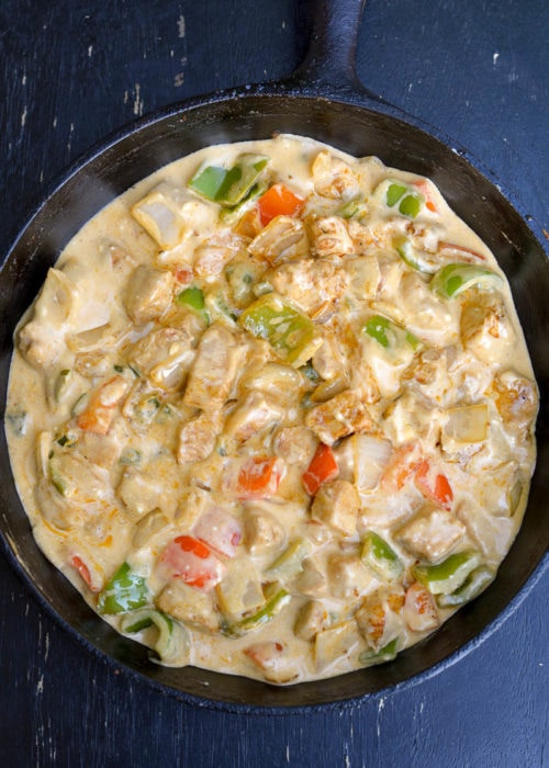 This One Pan Cheesy Fajita Chicken is a delicious combo of flavorful chicken, fresh veggies and an amazing cheese sauce your family will devour! Great for low carb meal-prepping and clean up is a breeze!