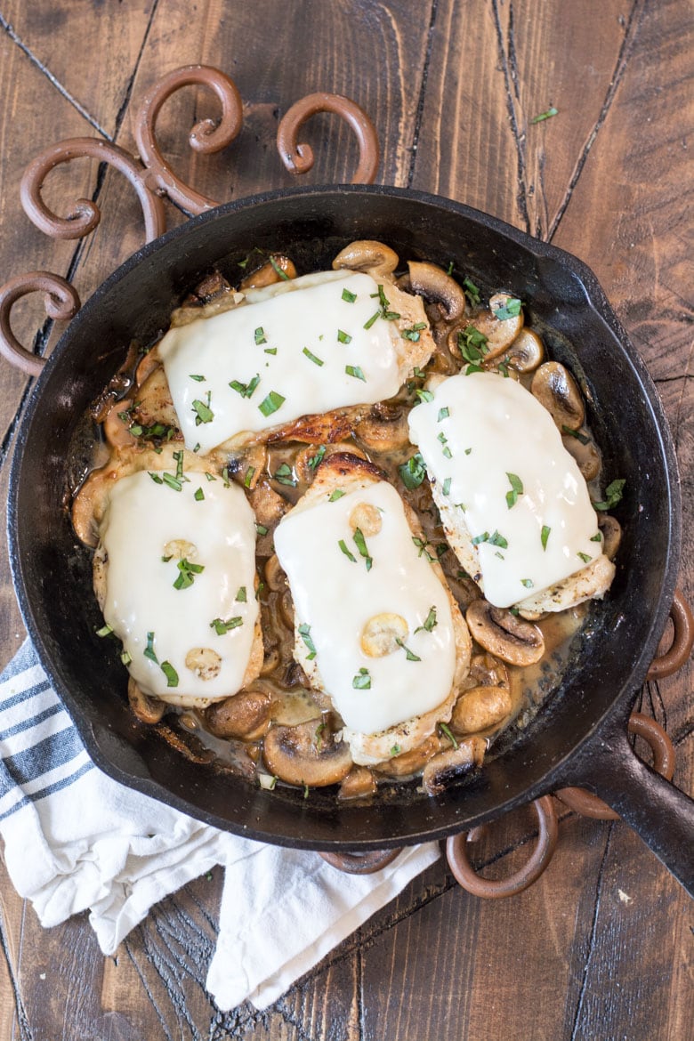 This One-Pan Keto Chicken and Mushroom Skillet is covered in Swiss cheese and swimming in a creamy mushroom sauce! This easy dinner is ready in under 30 minutes and has just 2 net carbs per serving!