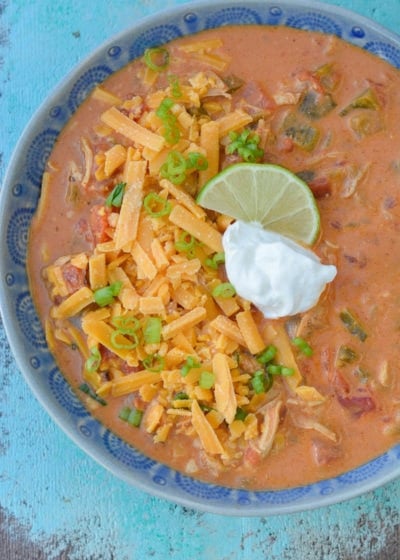 This Keto Cheesy Chicken Enchilada Soup has just about 6 net carbs and is super creamy! Top with shredded cheese, sour cream, green onions, and a squeeze of lime to bring it over the top!