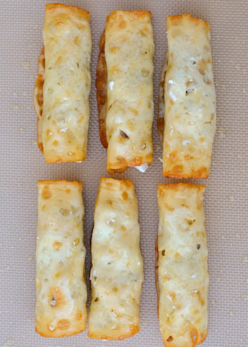 Spoon the creamy, cheesy, chicken filling onto the cheese slices and roll up for easy low-carb taquitos!