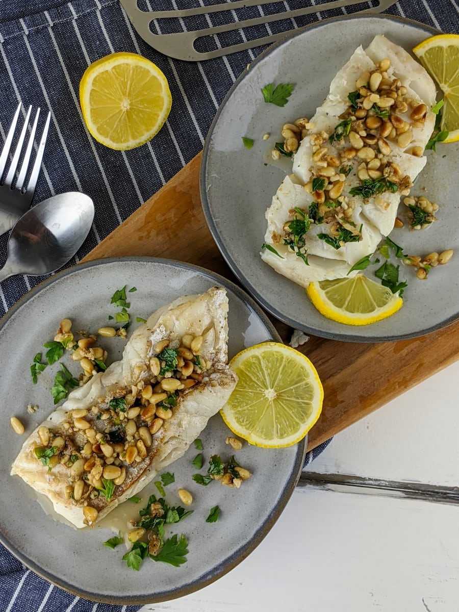 This keto-friendly cod recipe is covered in toasted pine nuts and drenched in a delicious lemon, garlic sauce.