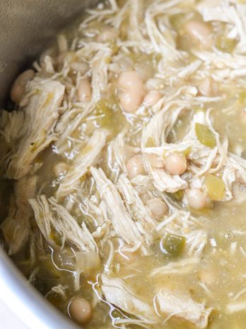 This Instant Pot White Bean Chicken Chili recipe is so easy! Loaded with chicken, beans, flavorful green chiles and spices this soup is ready in under 30 minutes and always a crowd pleaser! 