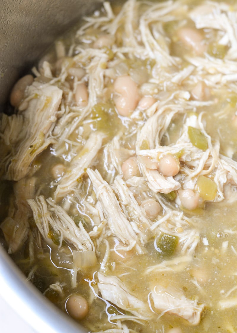 This Instant Pot White Bean Chicken Chili recipe is so easy! Loaded with chicken, beans, flavorful green chiles and spices this soup is ready in under 30 minutes and always a crowd pleaser! 