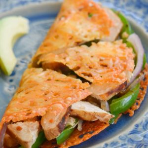 Learn how to make the perfect Keto Quesadilla! This low carb recipe is loaded with tender chicken, bell peppers and onions! This easy, low carb recipe has just 4 net carbs per serving!