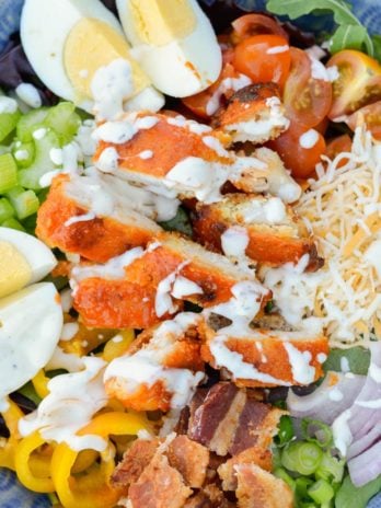 This Buffalo Chicken Cobb Salad is loaded with spicy chicken, crispy bacon, sharp cheddar cheese and loads of vegetables! Each generous serving has about 7 net carbs making it a great low carb dinner option! 