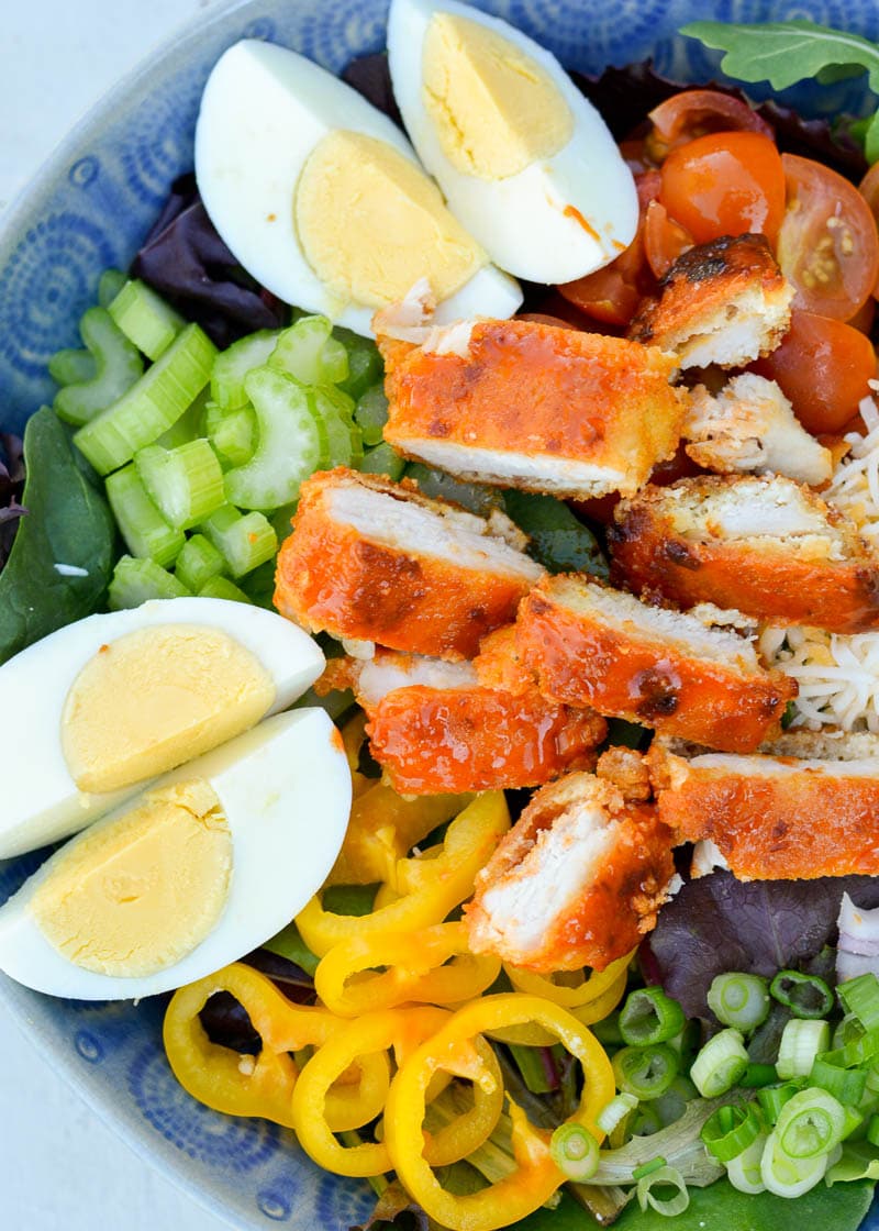 This Buffalo Chicken Cobb Salad is loaded with spicy chicken, crispy bacon, sharp cheddar cheese and loads of vegetables! Each generous serving has about 7 net carbs making it a great low carb dinner option! 