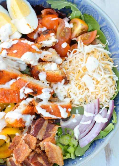 This Buffalo Chicken Cobb Salad is loaded with spicy chicken, crispy bacon, sharp cheddar cheese and loads of vegetables! Each generous serving has about 7 net carbs making it a great low carb dinner option! 