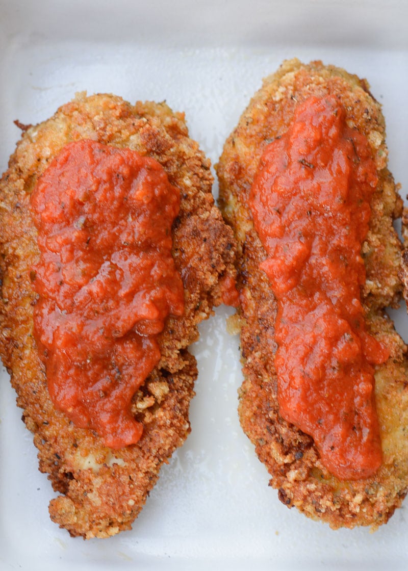 This Keto Chicken Parmesan is breaded and fried until perfectly crisp and smothered in marinara and mozzarella! At just five net carbs per serving this is a classic dish your entire family will love!