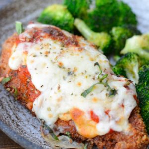 This Keto Chicken Parmesan is breaded and fried until perfectly crisp and smothered in marinara and mozzarella! At just five net carbs per serving this is a classic dish your entire family will love!