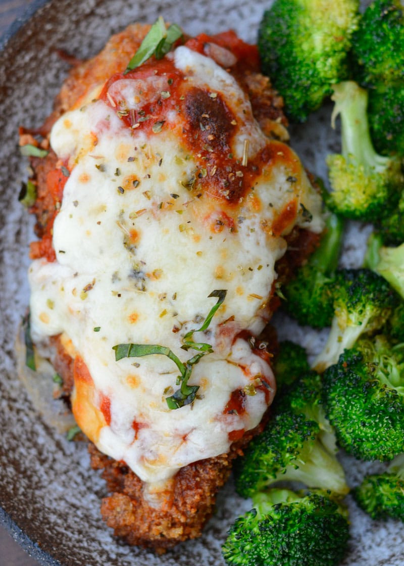 This Keto Chicken Parmesan is breaded and fried until perfectly crisp and smothered in marinara and mozzarella! At just five net carbs per serving this is a classic dish your entire family will love!