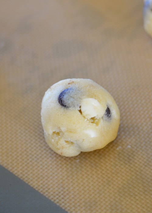 Using a 1-inch scoop, make the keto cookie dough balls and place on a silicone baking sheet.