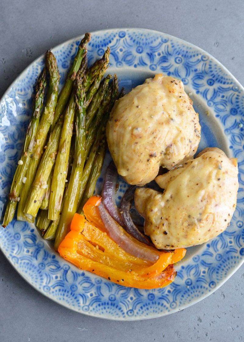 Try this Honey Mustard Chicken Sheet Pan Dinner for a quick weeknight meal! This keto chicken recipe features tender chicken thighs and roasted garlic butter vegetables for under 5 net carbs per serving!