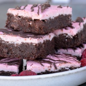 Enjoy these Keto Brownies with Frosting for a decadent sweet treat under 4 net carbs! Each grain free brownie is covered in Raspberry Frosting and rich dark chocolate. 