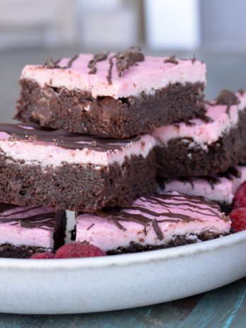 Enjoy these Keto Brownies with Frosting for a decadent sweet treat under 4 net carbs! Each grain free brownie is covered in Raspberry Frosting and rich dark chocolate. 