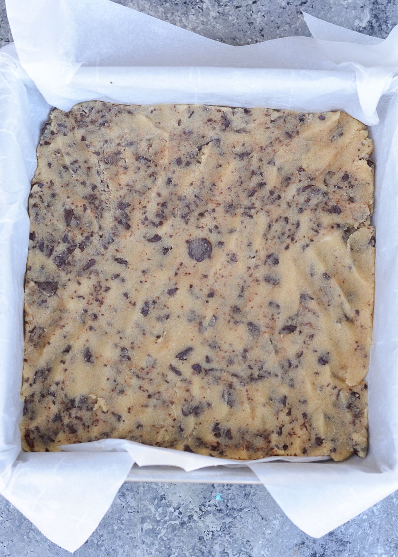 These Keto Chocolate Chip Cheesecake Bars combine sweet and delicious chocolate chip cookie dough with a creamy vanilla cheesecake layer! Each bar has less than 5 net carbs and is gluten free and keto-friendly! 