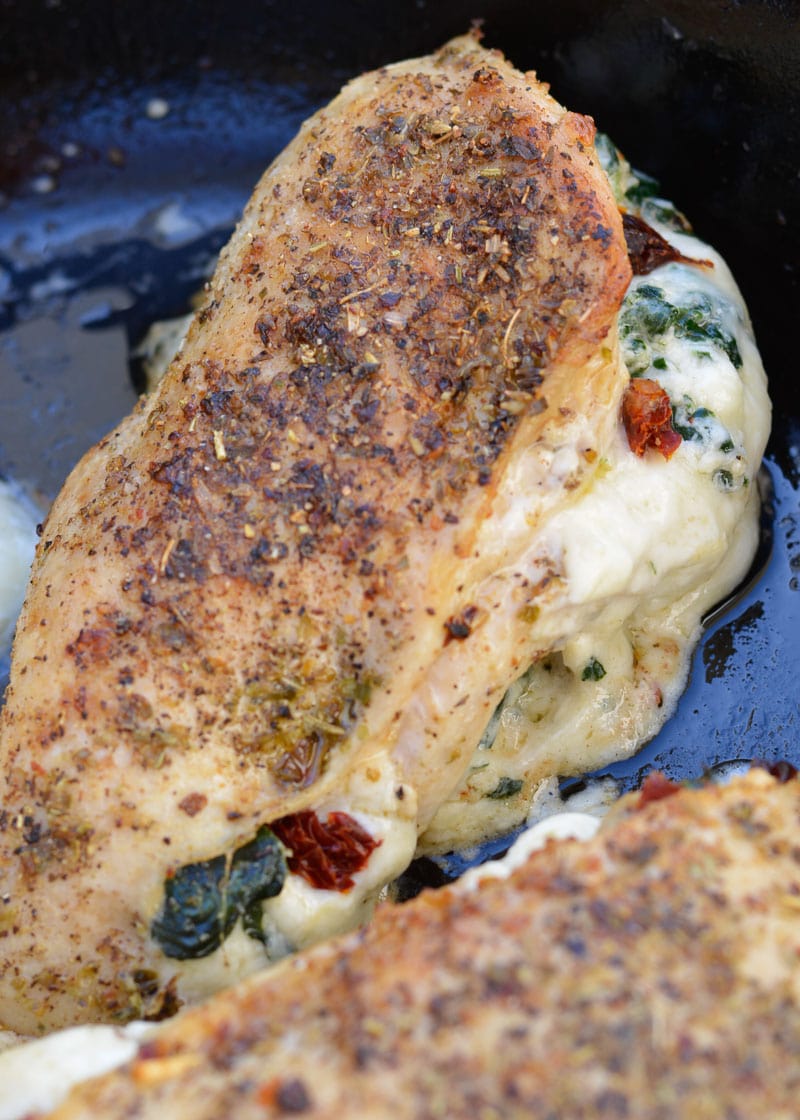 This easy Spinach Stuffed Chicken recipe is stuffed with cheese, tender spinach and delicious sun dried tomatoes! This one pan recipe is naturally low carb and comes together in 30 minutes!