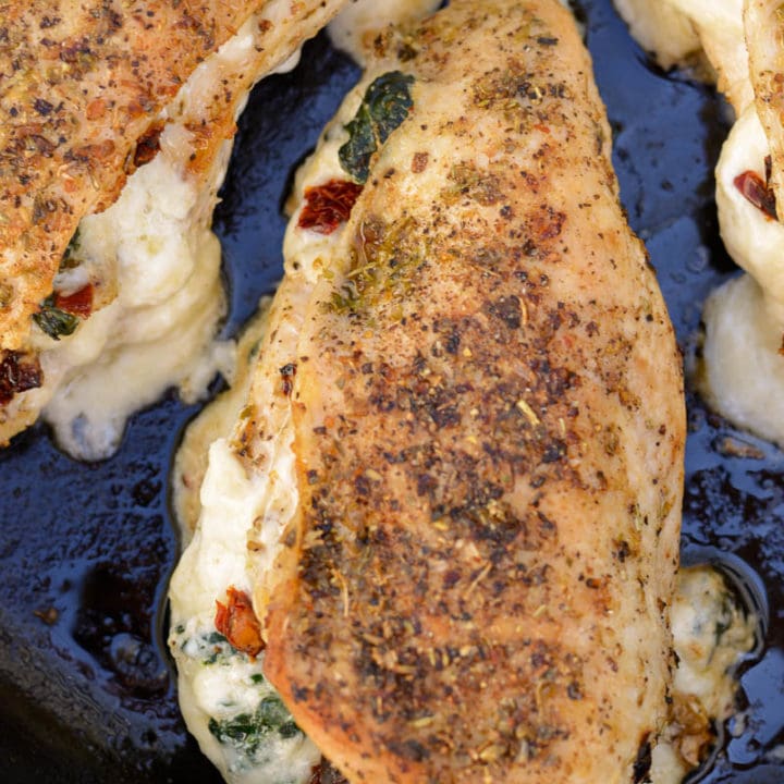 This easy Spinach Stuffed Chicken recipe is stuffed with cheese, tender spinach and delicious sun dried tomatoes! This one pan recipe is naturally low carb and comes together in 30 minutes!