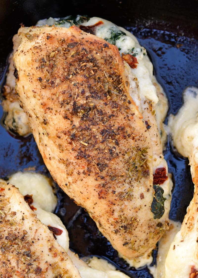 This easy Spinach Stuffed Chicken recipe is stuffed with cheese, tender spinach and delicious sun dried tomatoes! This one pan recipe is naturally low carb and comes together in 30 minutes!