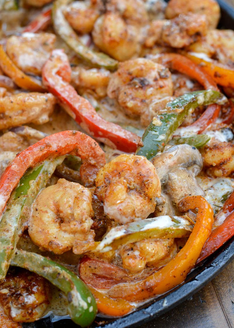 Impress your family with this delicious Shrimp Con Queso! This one pan, 20 minute meal features shrimp fajitas covered in a homemade queso sauce!