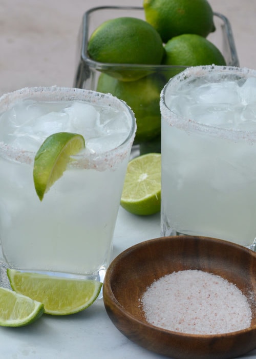 This Keto Margarita is a low-carb, low-calorie dream! Using a sugar-free simple syrup makes this skinny keto alcoholic drink under 2 net carbs and about 100 calories each– perfect for Taco Tuesday!