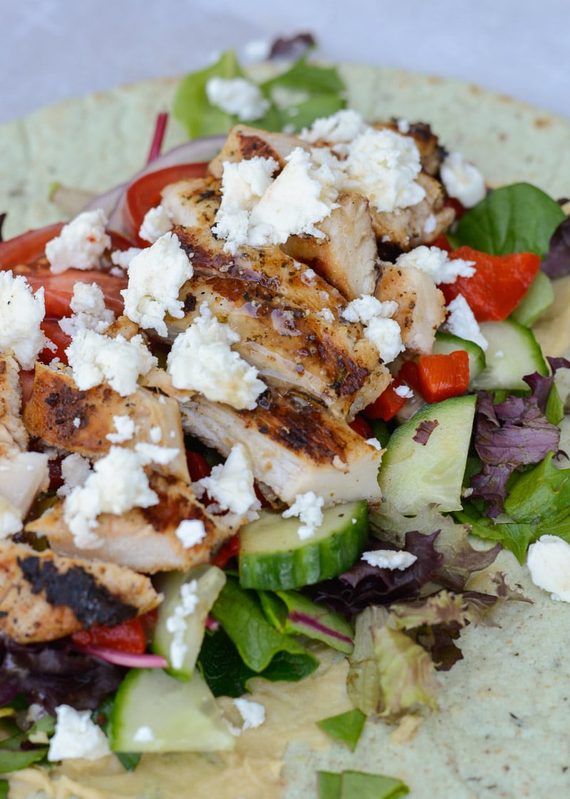 This easy Greek Chicken Wrap is the perfect healthy lunch idea! A soft wrap is loaded with grilled chicken, vegetables, hummus, feta and olives!