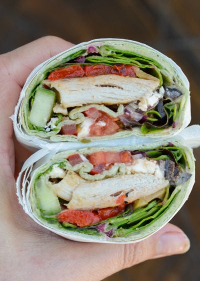 This easy Greek Chicken Wrap is the perfect healthy lunch idea! A soft wrap is loaded with grilled chicken, vegetables, hummus, feta and olives!