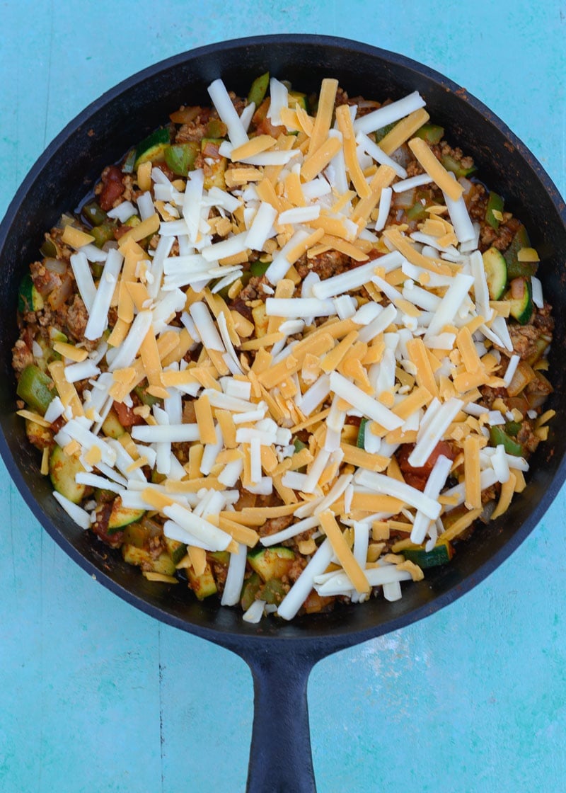 Keto Taco Casserole is the perfect healthy dinner recipe! This low carb dinner is packed with taco meat, zucchini, peppers, onions, tomatoes and cheese! 